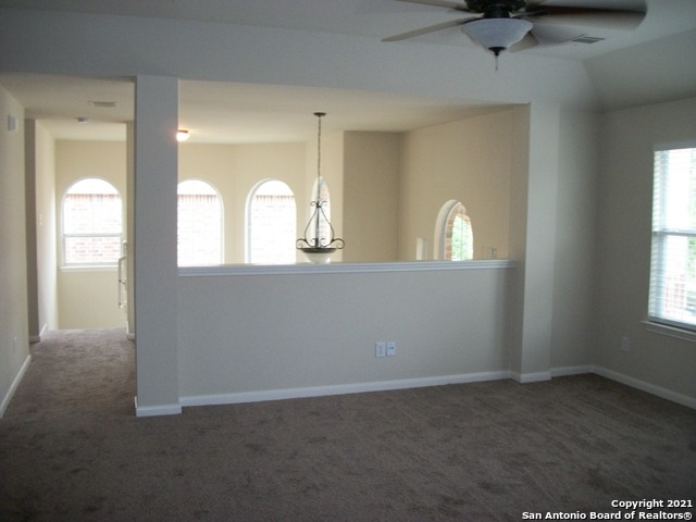 16202 Juan Tabo Way Helotes, TX 78023 - Photo 17 of 22 an empty room with windows and mirror