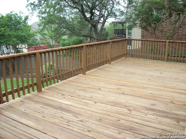 a view of a terrace with wooden floor and fence
