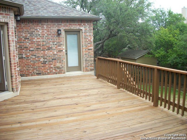 16202 Juan Tabo Way Helotes, TX 78023 - Photo 22 of 22 a view of a terrace with wooden floor and fence