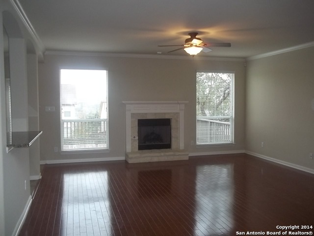16202 Juan Tabo Way Helotes, TX 78023 - Photo 3 of 22 a view of an empty room with wooden floor and a window