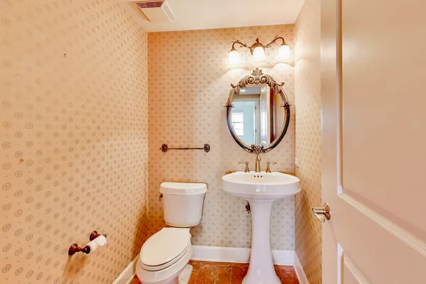 a bathroom with a granite countertop tub sink and mirror