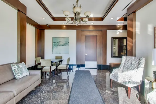 a living room with furniture and a chandelier