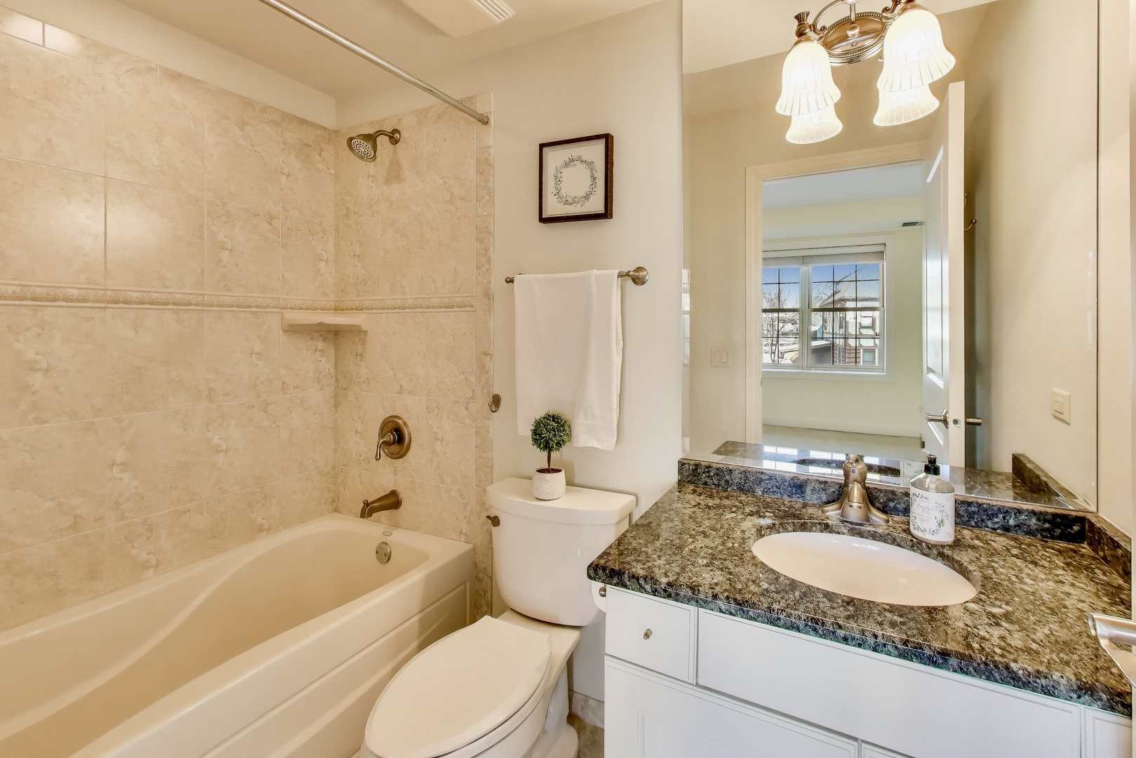 10 East Burlington Street, Unit 2C Riverside, IL 60546 - Photo 25 of 53 a bathroom with a granite countertop tub sink and mirror
