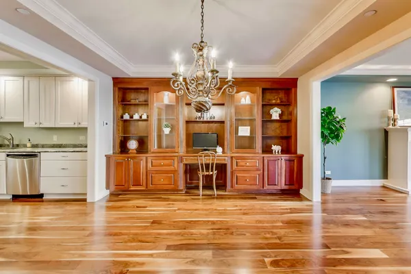 a view of a room with wooden floor and large windows