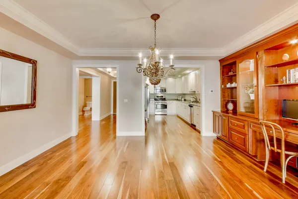 a kitchen with kitchen island granite countertop a sink cabinets and stainless steel appliances