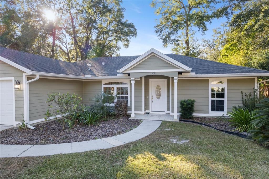 5732 Southwest 85th Street Gainesville, FL 32608 - Photo 1 of 1 a front view of a house with garden