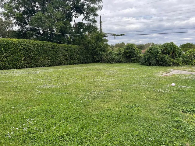 a view of a field with an ocean