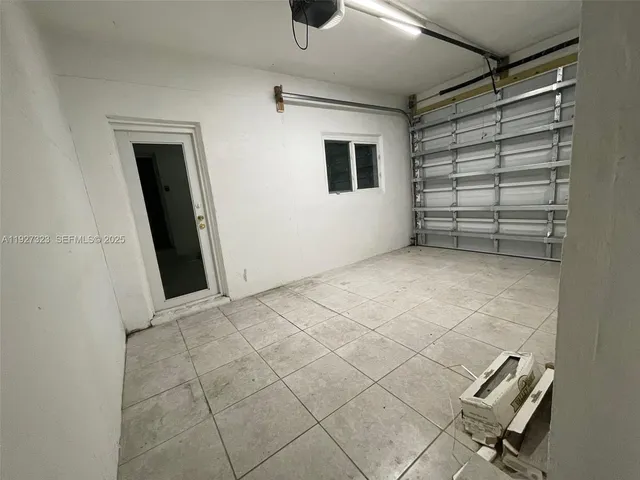 a view of a livingroom with an empty space and a window