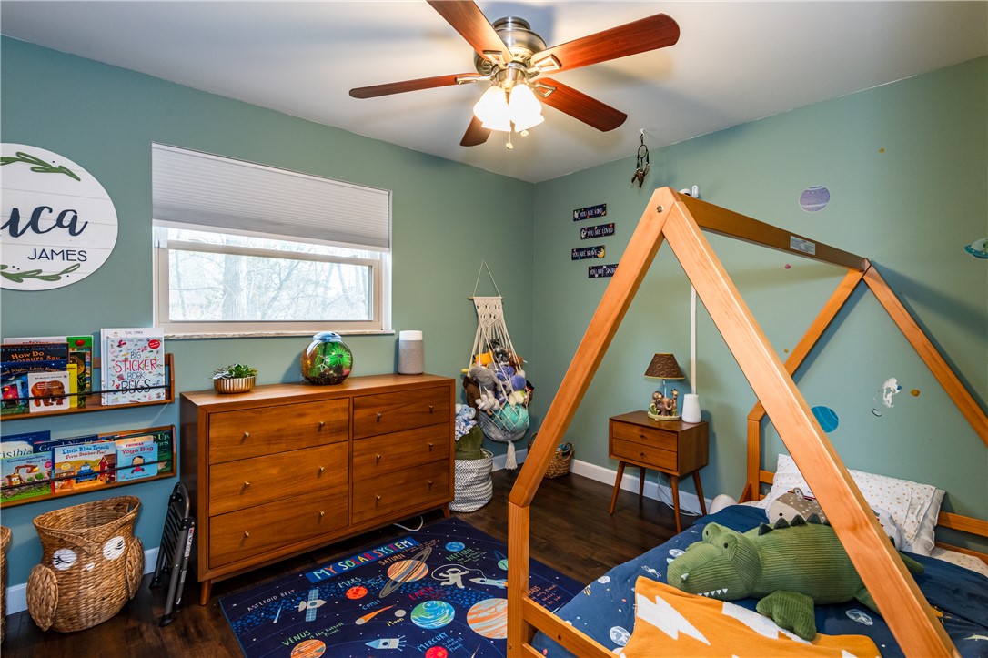 4102 Ridgetop Drive Bellbrook, OH 45305 - Photo 21 of 33 This cozy bedroom offers a tranquil retreat with warm wood flooring and ample natural light.