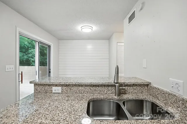 a kitchen with a sink and washing machine