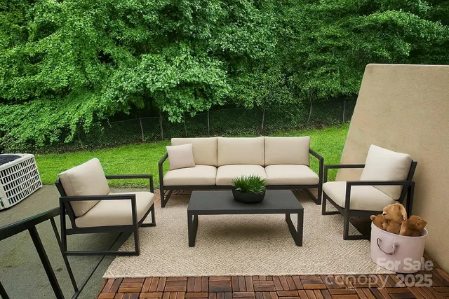 a backyard of a house with table and chairs