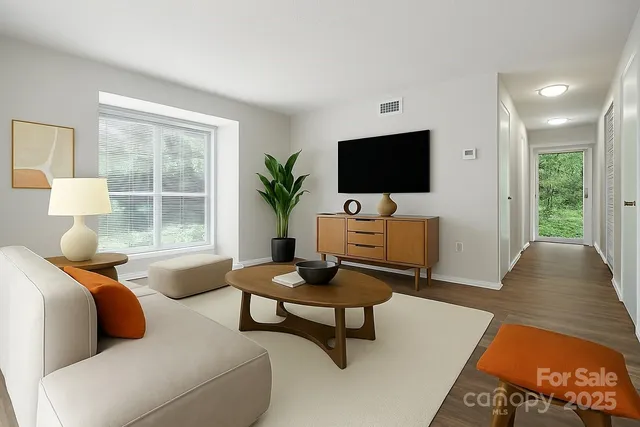 a living room with furniture and a flat screen tv