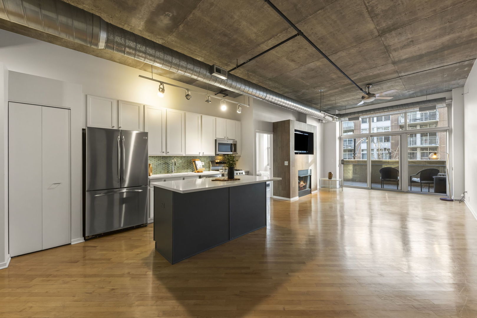 1000 West Adams Street, Unit 302 Chicago, IL 60607 - Photo 2 of 19 a large kitchen with stainless steel appliances granite countertop a refrigerator and a stove