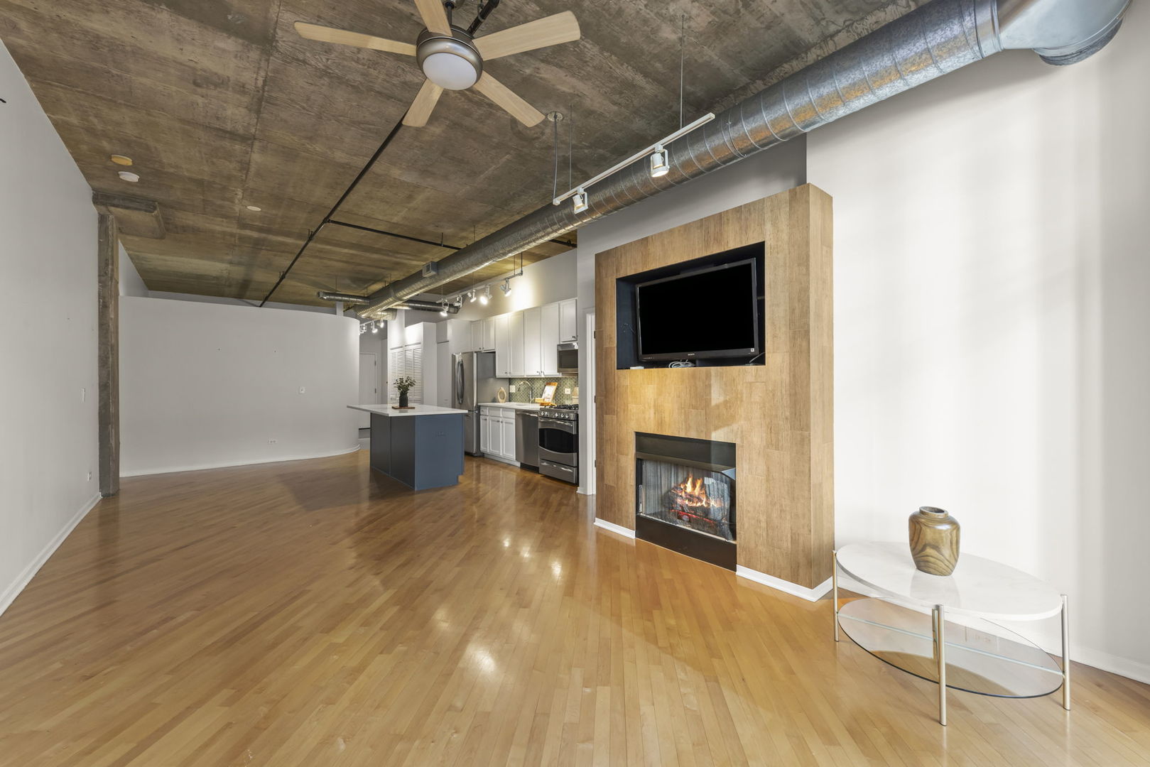 1000 West Adams Street, Unit 302 Chicago, IL 60607 - Photo 4 of 19 a view of a livingroom with a fireplace and furniture