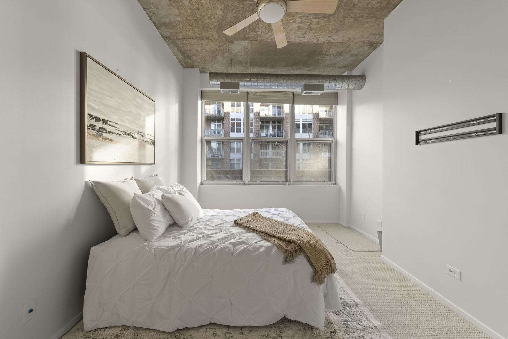 1000 West Adams Street, Unit 302 Chicago, IL 60607 - Photo 7 of 19 a bedroom with a large bed and a large window