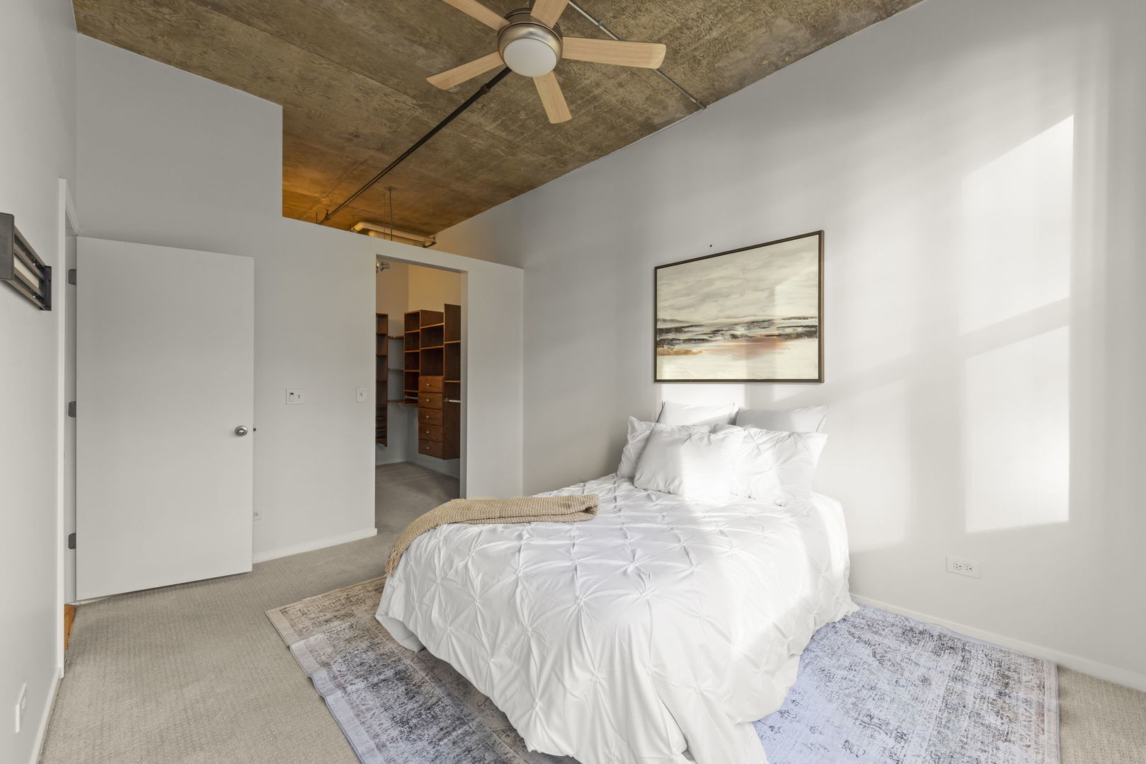 1000 West Adams Street, Unit 302 Chicago, IL 60607 - Photo 8 of 19 a bedroom with a large bed and a window