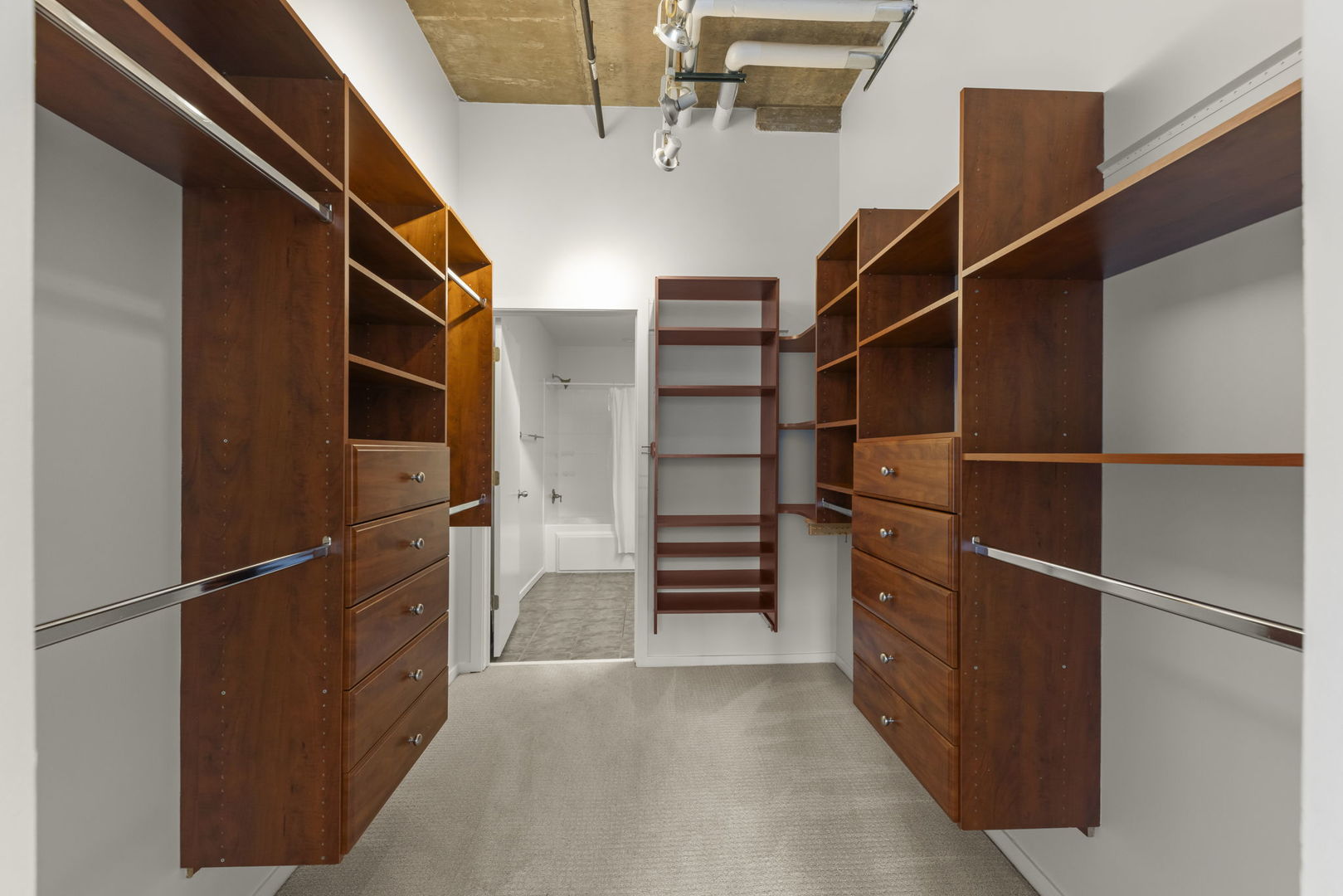 1000 West Adams Street, Unit 302 Chicago, IL 60607 - Photo 9 of 19 a view of walk in closet with empty racks