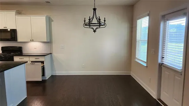 a view of a kitchen with a sink cabinets and wooden floor