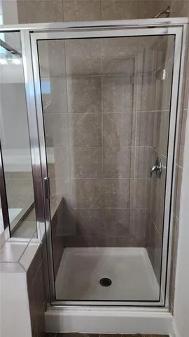 a bathroom with a glass shower door