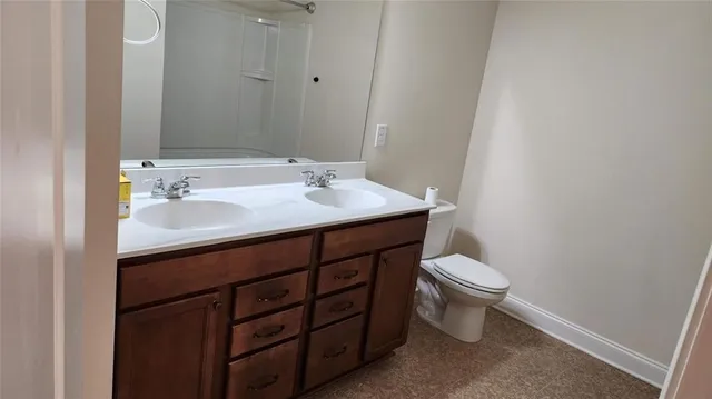 a bathroom with a sink a toilet and mirror