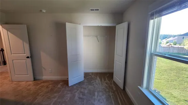 an empty room with wooden floor and a window