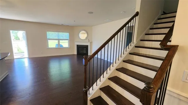 a view of entryway and hall with wooden floor