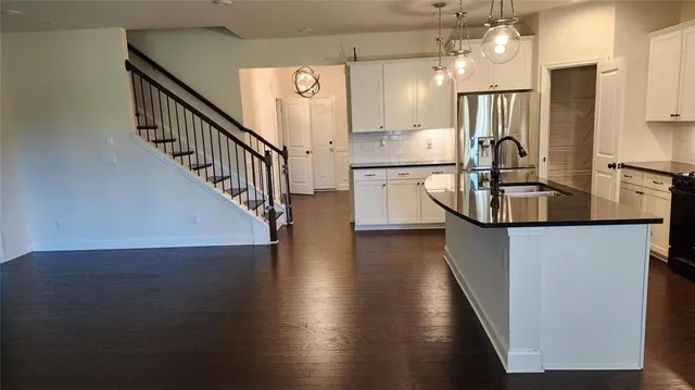 a view of a kitchen with wooden floor and a sink