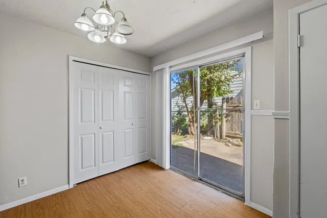 a kitchen that has a sink and a stove with wooden floor