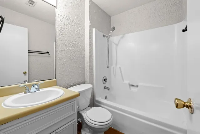 an empty room with closet and windows