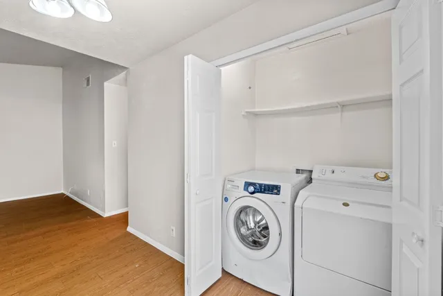 an empty room with a window and ceiling fan