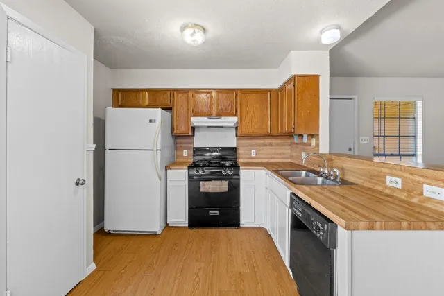 a kitchen with a refrigerator stove and a sink