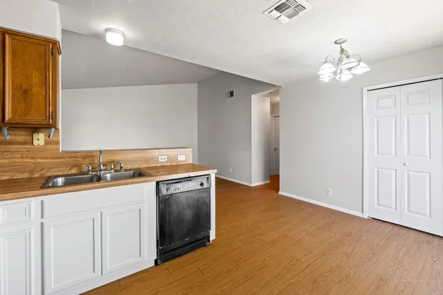 a kitchen with a refrigerator and a stove top oven