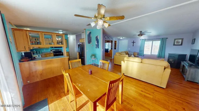 a view of a dining room with furniture and wooden floor