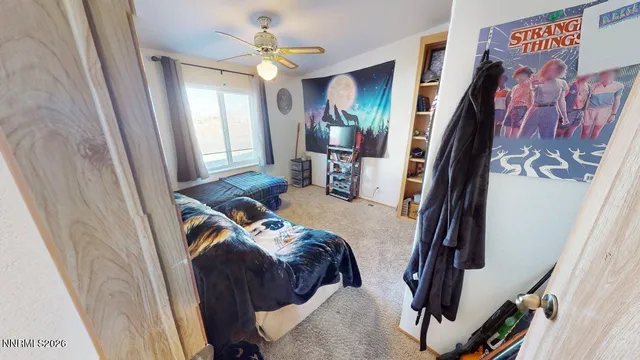 a bedroom with furniture and a large window