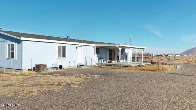 a view of a house with backyard porch and furniture