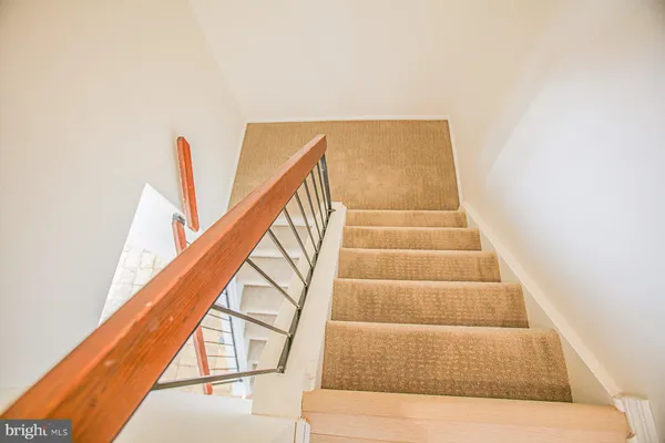 a view of staircase with white walls