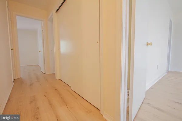 a view of hallway with wooden floor