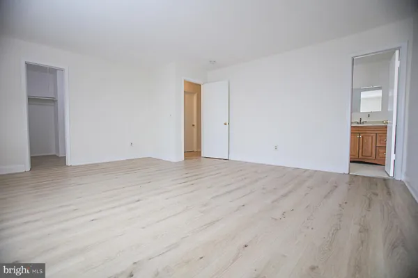 a view of an empty room and wooden floor