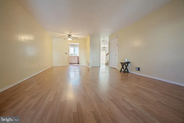 a view of a room with wooden floor and a window