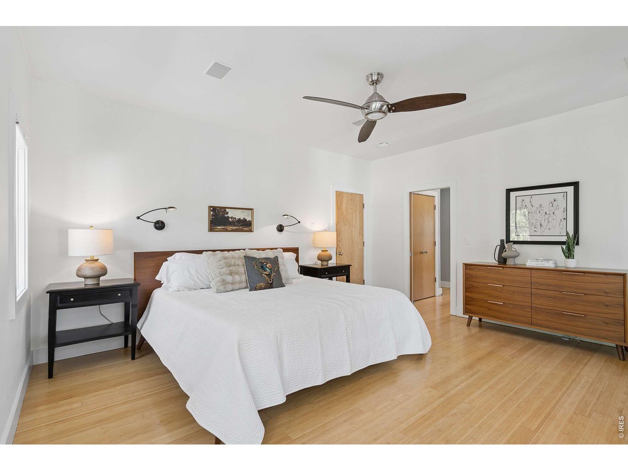 821 Incorrigible Circle Longmont, CO 80504 - Photo 18 of 43 a bedroom with a bed and wooden floor