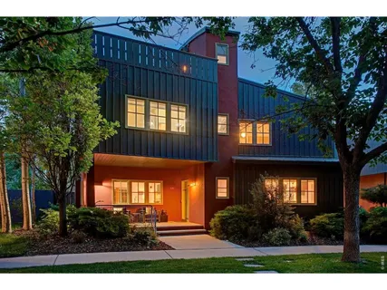 a kitchen with stainless steel appliances kitchen island granite countertop a dining table chairs and granite counter tops