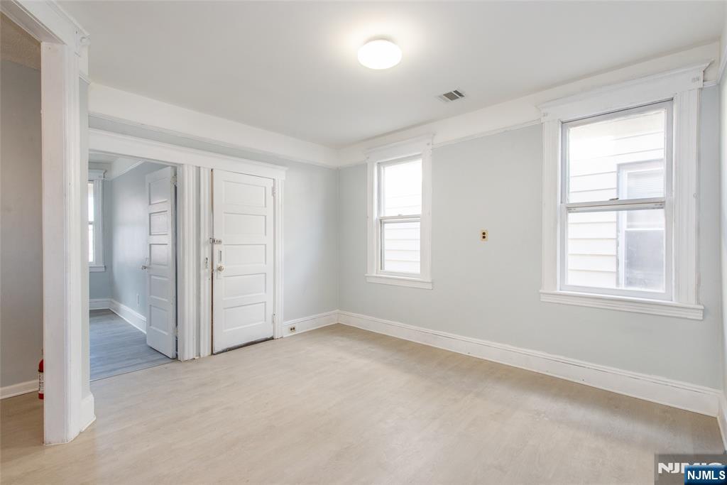 51 Maple Street Garfield, NJ 07026 - Photo 4 of 12 an empty room with windows and closet