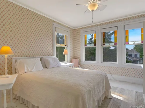 a bedroom with a large bed and a chandelier