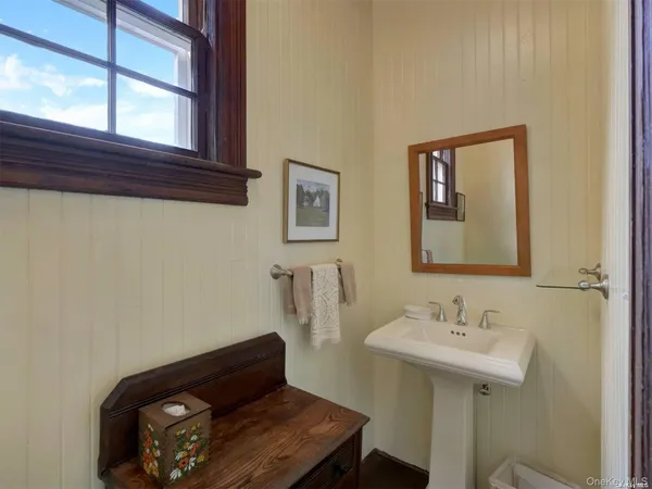a bathroom with a sink a mirror and a toilet