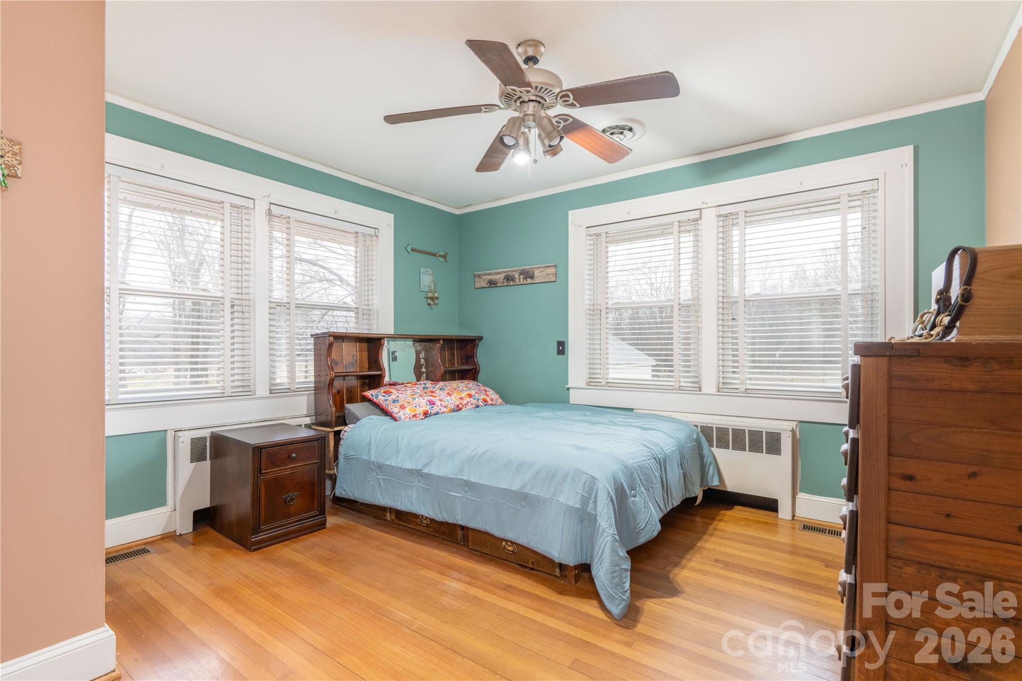 6507 Frieden Church Road Gibsonville, NC 27249 - Photo 31 of 45 a bedroom with a bed and wooden floor