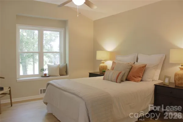 a bedroom with a bed and a window