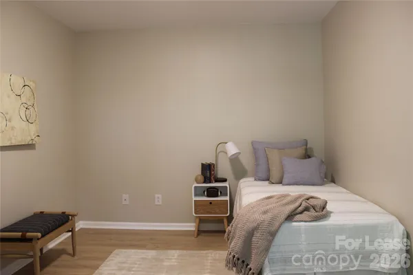 a bedroom with a bed and a chair