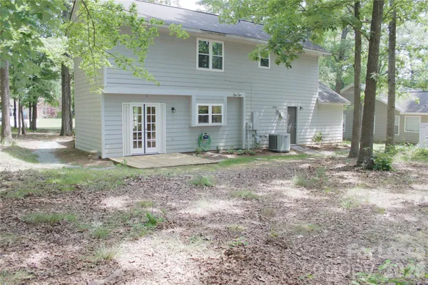 a view of a house with yard and a tree