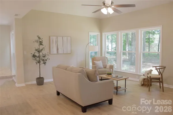 a living room with furniture and a large window