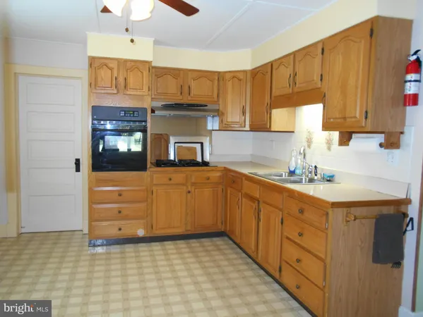 a kitchen with a sink a stove and cabinets